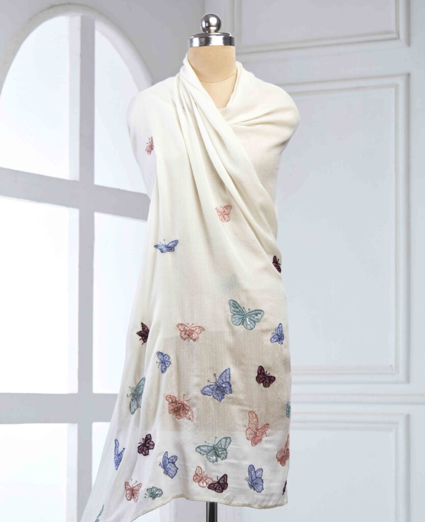 Hand-embroidered butterflies come alive in silk threads and beaded embellishments in soft, scattered hues.